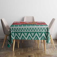 Christmas tablecloth with green and white chevron motifs and a small red border strip.
