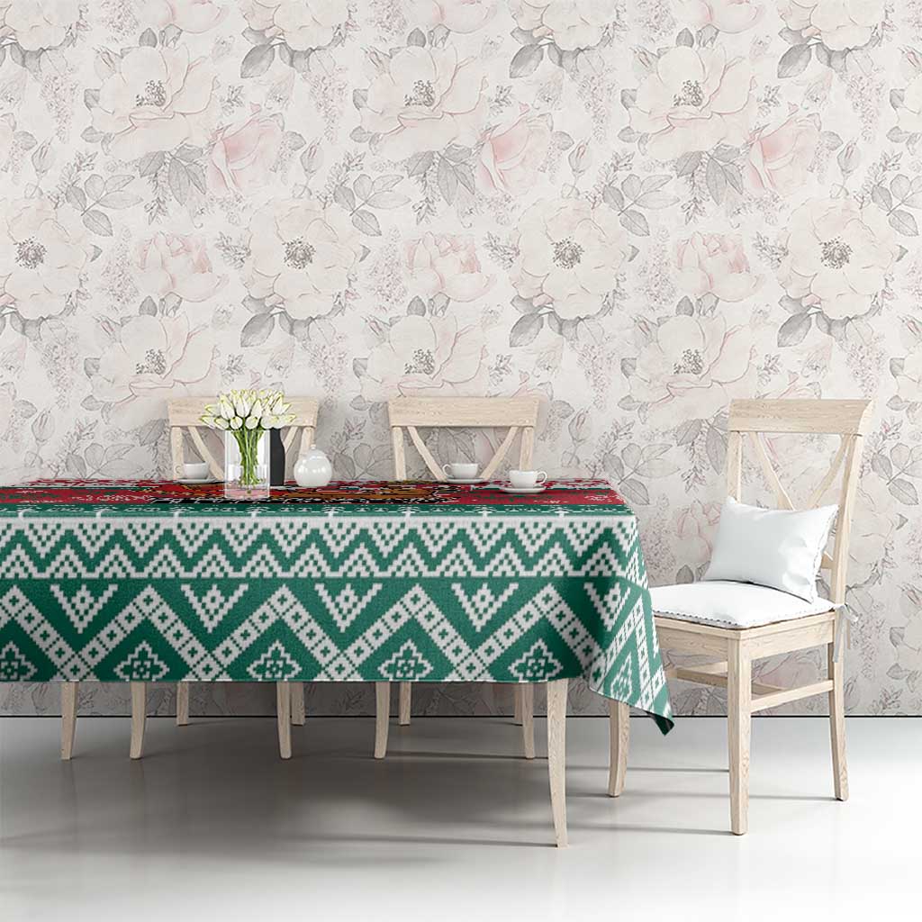 Christmas tablecloth in green and white diamond patterns with a red accent strip along the top.