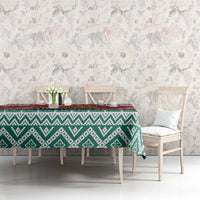 Christmas tablecloth in green and white diamond patterns with a red accent strip along the top.