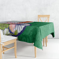 Green lotus floral paisley tablecloth draped over table with colorful floral India motif