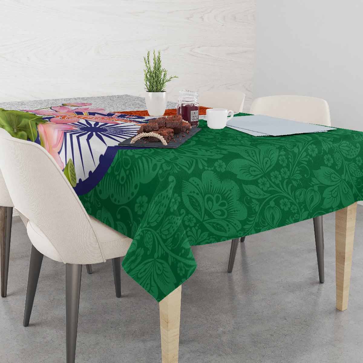 Green tablecloth with paisley leaf pattern and colorful lotus flower India emblem