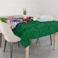 Green tablecloth with paisley leaf pattern and colorful lotus flower India emblem