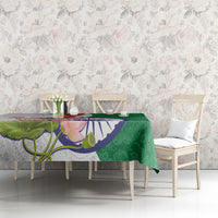 Green floral paisley tablecloth with colorful lotus flower and India emblem on table