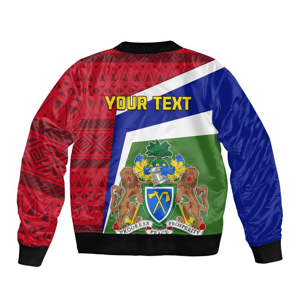 Unisex bomber jacket back with red geometric print, blue panels, green crest graphic, ribbed hem