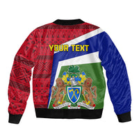 Unisex bomber jacket back with red geometric print, blue panels, green crest graphic, ribbed hem