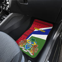 Car floor mat with red geometric pattern, tricolor flag crest, and green backing