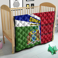 Gambia flag quilt on baby crib mattress, red and green panels with coat of arms