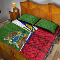 Quilt bed set featuring green quilted squares, red geometric pattern, and emblem stripe