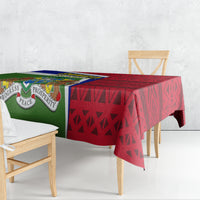 Gambia Independence Day tablecloth draped over table with red geometric and green emblem panels