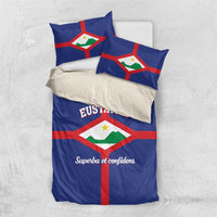 Blue bedding set with flag crest on duvet and two matching pillowcases.