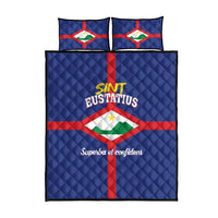 Blue quilt bed set with centered flag emblem, red cross stripes, and two pillows