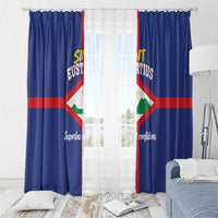 Blue curtains with Sint Eustatius flag print and pleated top, bedroom window view