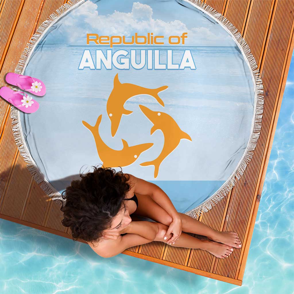 Round blue blanket with fringe edge, Republic of Anguilla print; woman lounging on it.