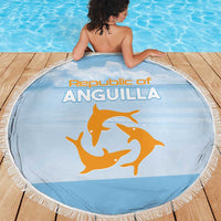 Round blue beach blanket with fringe edge, Republic of Anguilla print and orange dolphin graphic.