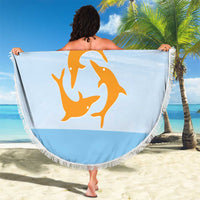 Round blue beach blanket with fringe edge, Republic of Anguilla dolphin print held over sand.
