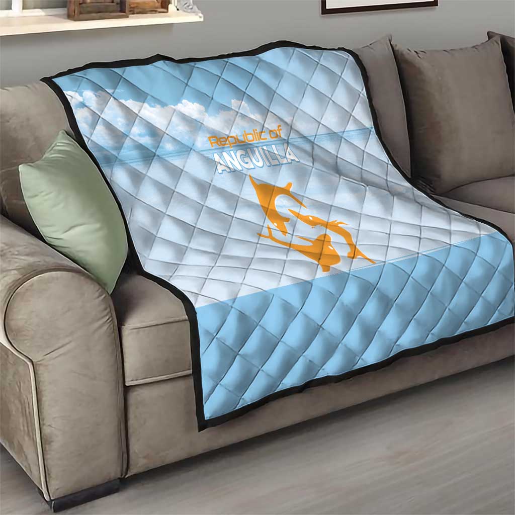Light blue diamond-stitched quilt on a sofa with Republic of Anguilla orange logo