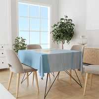 Blue tablecloth on round dining table, Republic of Anguilla graphic centered