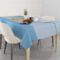Blue tablecloth with orange Republic of Anguilla graphic, dining table setup