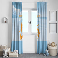 Blue window curtain set with gold animal and cloud print, centered over a doorway.