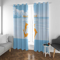 Blue window curtains with gold animal and cloud print, mounted on a rod with rings.