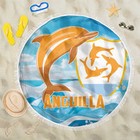 Round blue beach blanket with orange dolphin graphic and white fringe edging.