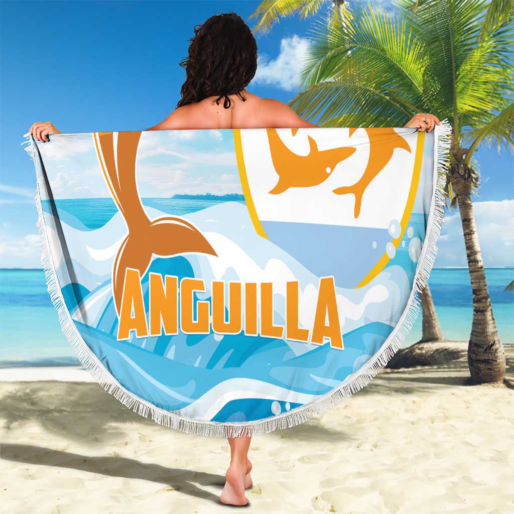 Round blue beach blanket with orange dolphin emblem, 'ANGUILLA' lettering, white fringe.