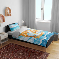 Blue bedding set on bed with orange dolphin emblem and ocean wave design, duvet with pillows