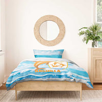 Blue comforter and pillow set with orange dolphin logo and ocean wave print