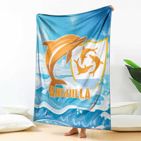 Anguilla blanket, blue with orange dolphin emblem and waves, spread on floor