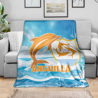 Anguilla blanket, blue with orange dolphin and wave print, laid over gray sofa