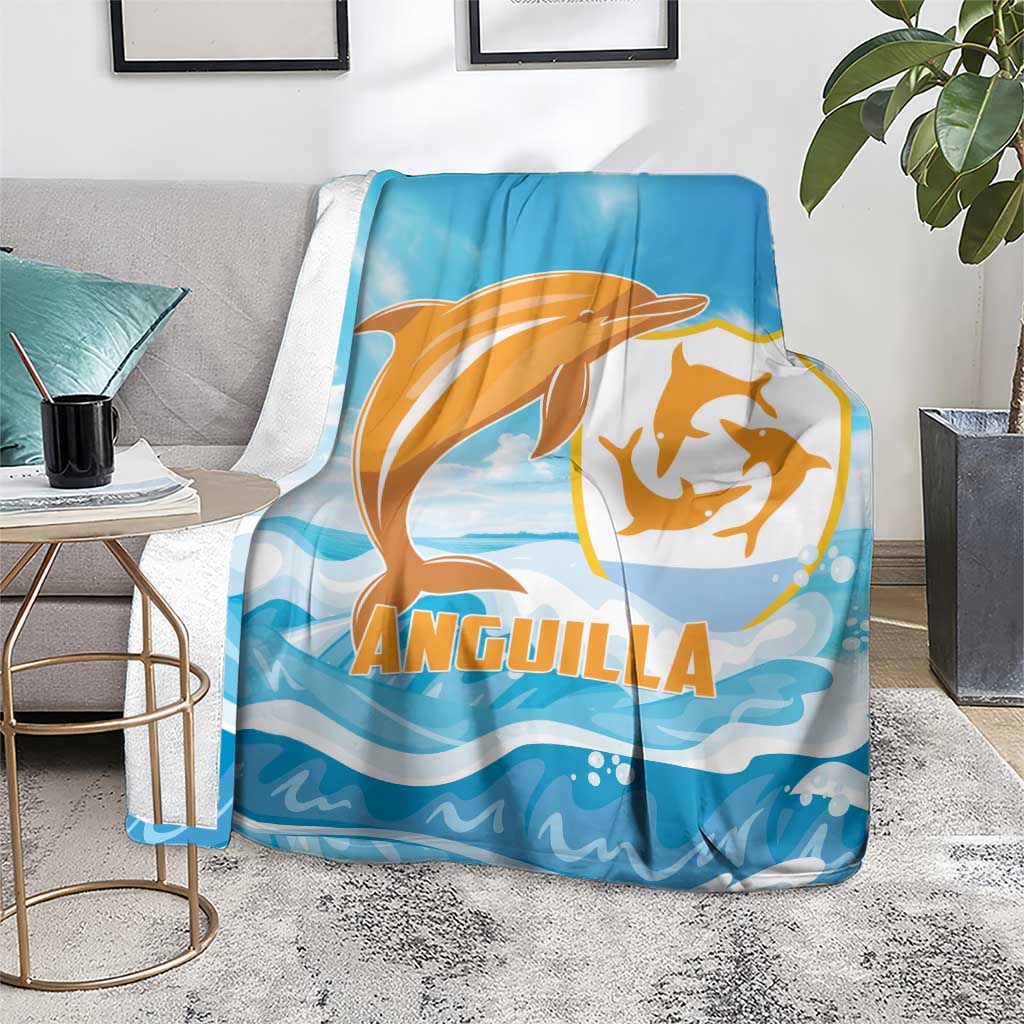 Anguilla blanket, blue with orange dolphin artwork and ANGUILLA text, on rug