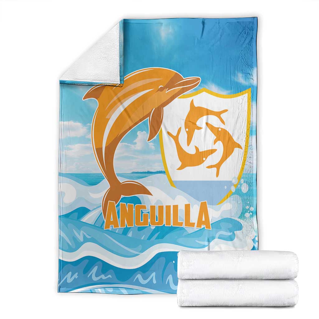 Anguilla blanket, blue with orange dolphin emblem and waves, folded with white towels
