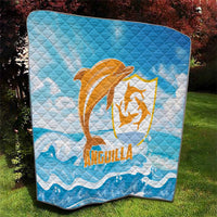 Blue quilt blanket with centered orange Anguilla dolphin logo and diamond stitched pattern