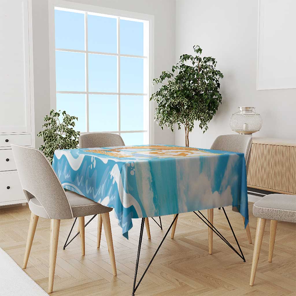 Blue dolphin-themed tablecloth with orange and gold graphic on a dining table.
