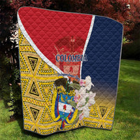 Quilt on grass, red, white, blue, and yellow geometric pattern with Colombia shield graphic