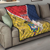 Quilt draped on sofa, red-white diagonal panel over navy blue with yellow geometric pattern
