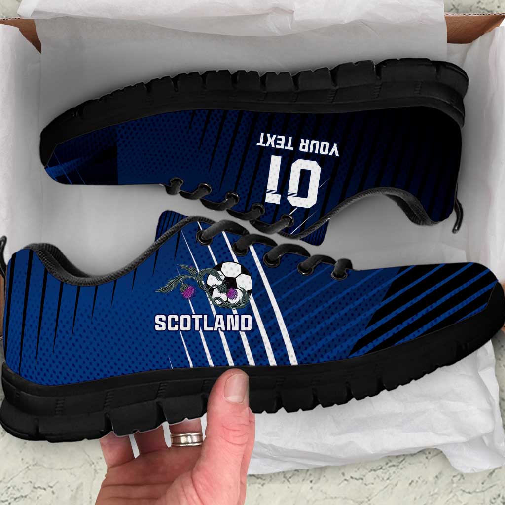 Blue lace-up football sneakers with Scotland graphic, soccer ball emblem, black sole