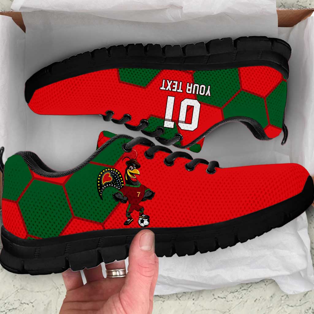 Red and green football sneakers with black soles and black laces, side view