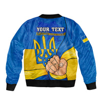 Blue bomber jacket back print: 'YOUR TEXT' over trident and hand graphic, black ribbed hem