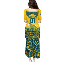Teal and yellow long jersey dress with short sleeves, number 01 and aboriginal-style pattern on back