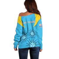 Back view of blue off-shoulder rugby sweater with Los Teros print and yellow shoulder
