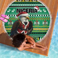 Round green beach blanket with Nigeria word, eagle in Santa suit, and white tassel fringe.