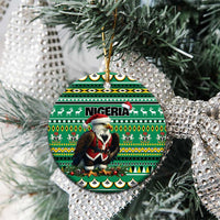 Green ceramic round ornament with Nigeria pattern and Santa figure, hanging on Christmas tree