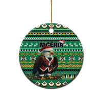 Green ceramic round ornament with Nigeria pattern and Santa figure, hanging from gold loop