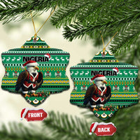 Green ceramic ornament pair with Nigeria pattern and Santa figure, hanging on gold loops