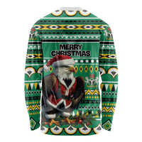 Unisex green long-sleeve Christmas shirt with eagle Santa scene and tribal pattern, Merry Christmas