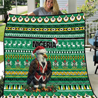 Green quilt with Eagle Santa, Nigeria text, reindeer, and geometric border patterns