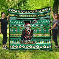 Green quilt with Eagle Santa, Nigeria lettering, reindeer silhouettes, and striped geometric bands