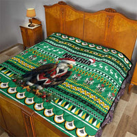 Green bed quilt with Eagle Santa graphic, Nigeria text, reindeer motifs, and geometric stripes