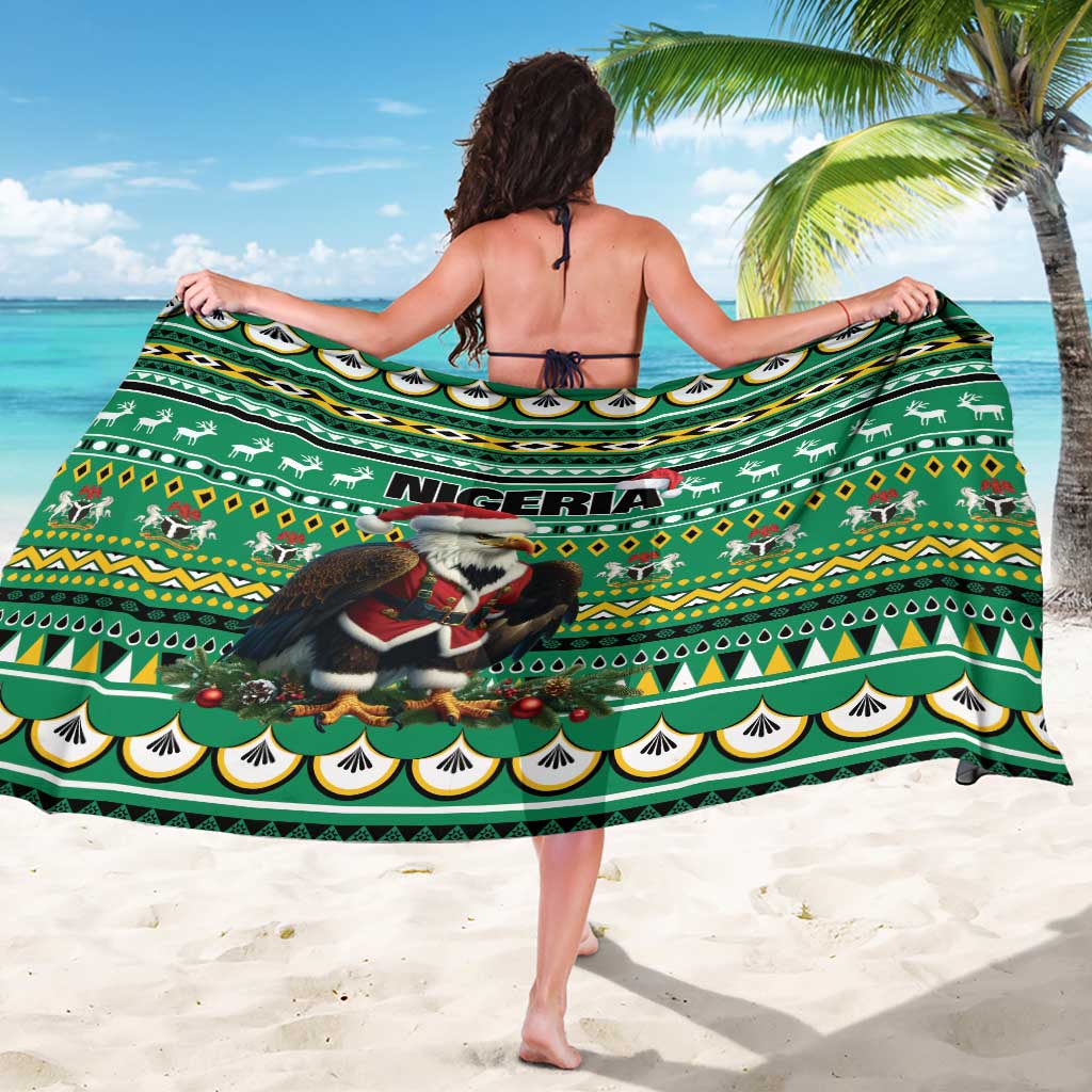 Green sarong laid flat with Nigeria text, Santa-eagle graphic, and geometric border